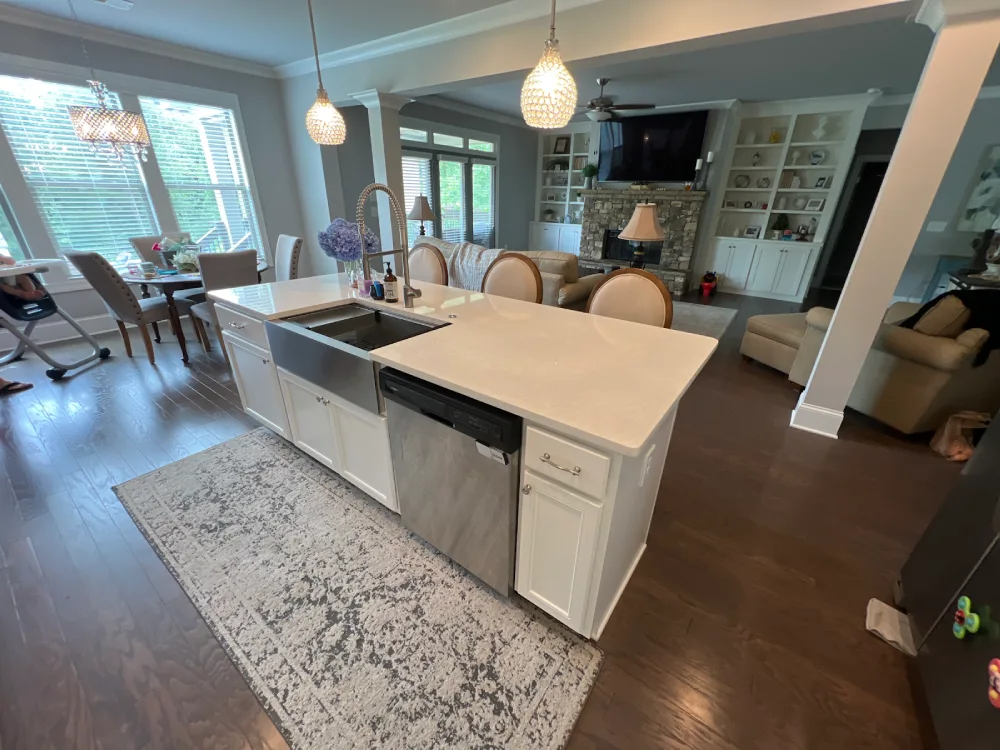 A well-designed kitchen with a prominent island and a sink, emphasizing a contemporary and open space