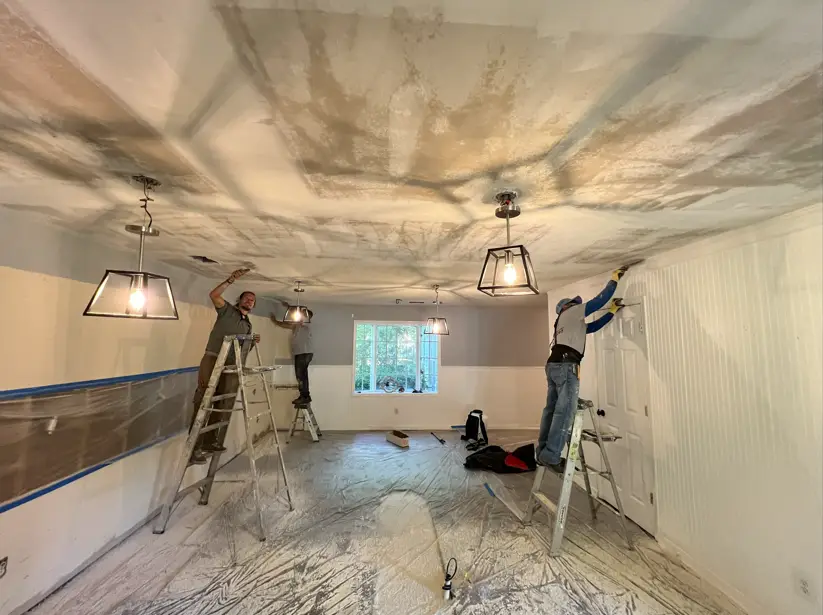 Professional crew working on kitchen remodeling with lighting and countertop updates